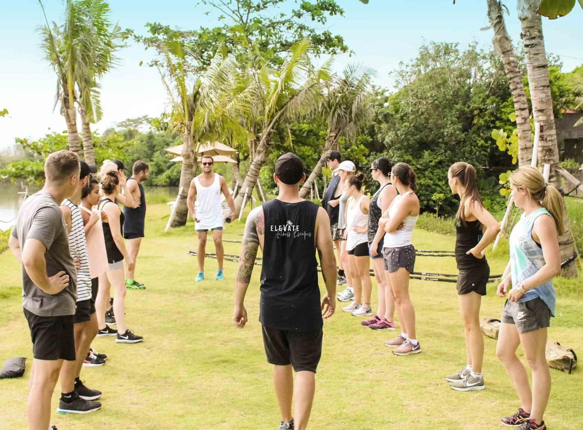 Fitness group gathered outdoors in Bali for a retreat session